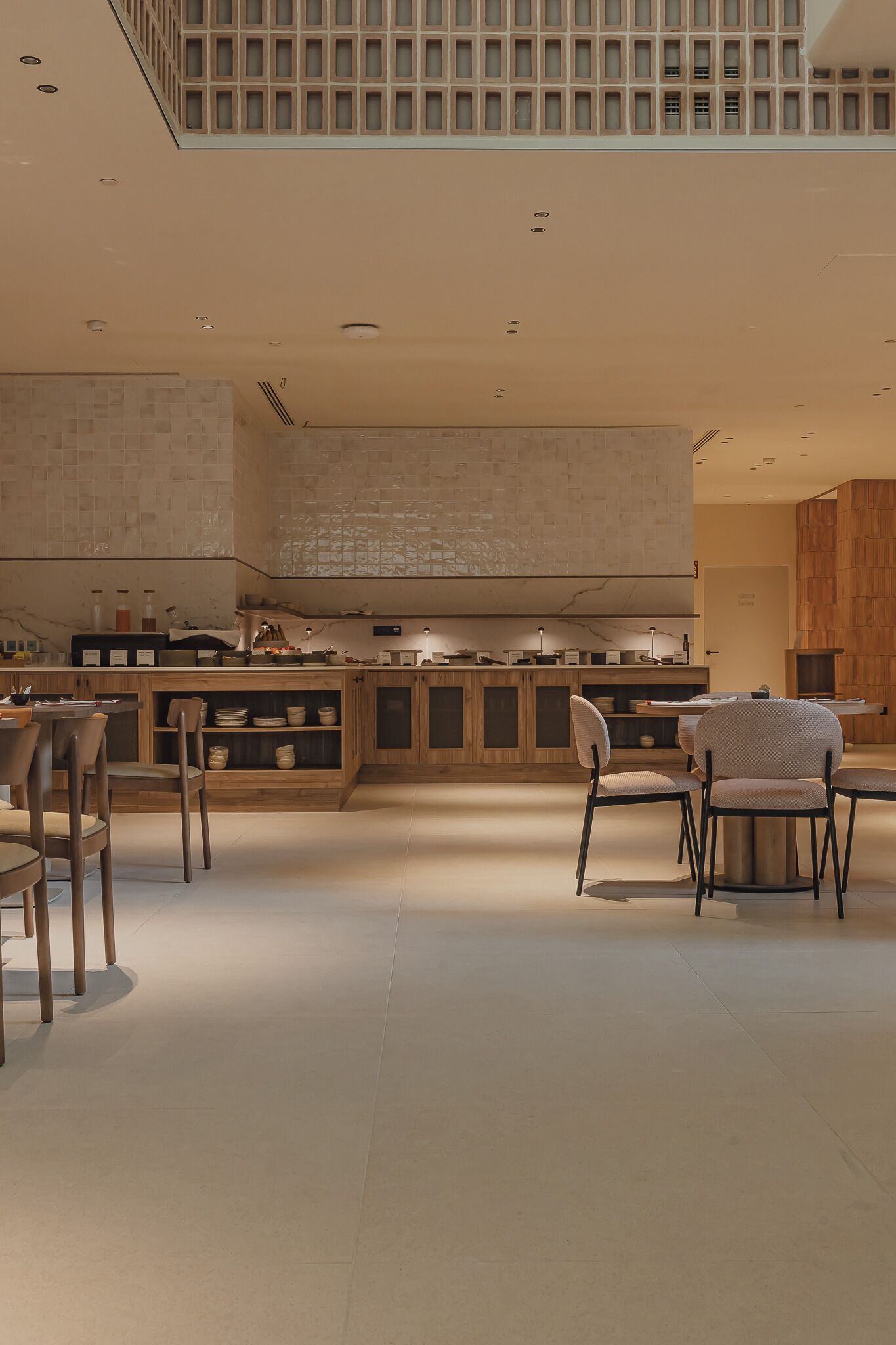 A modern interior with a kitchen area, seating arrangement, and a mezzanine level.