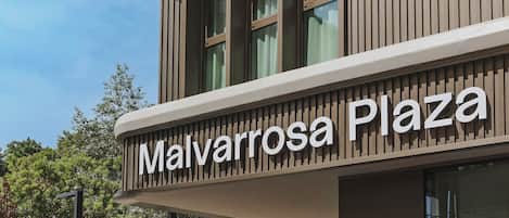 A building with a sign reading 'Malvarrosa Plaza'.