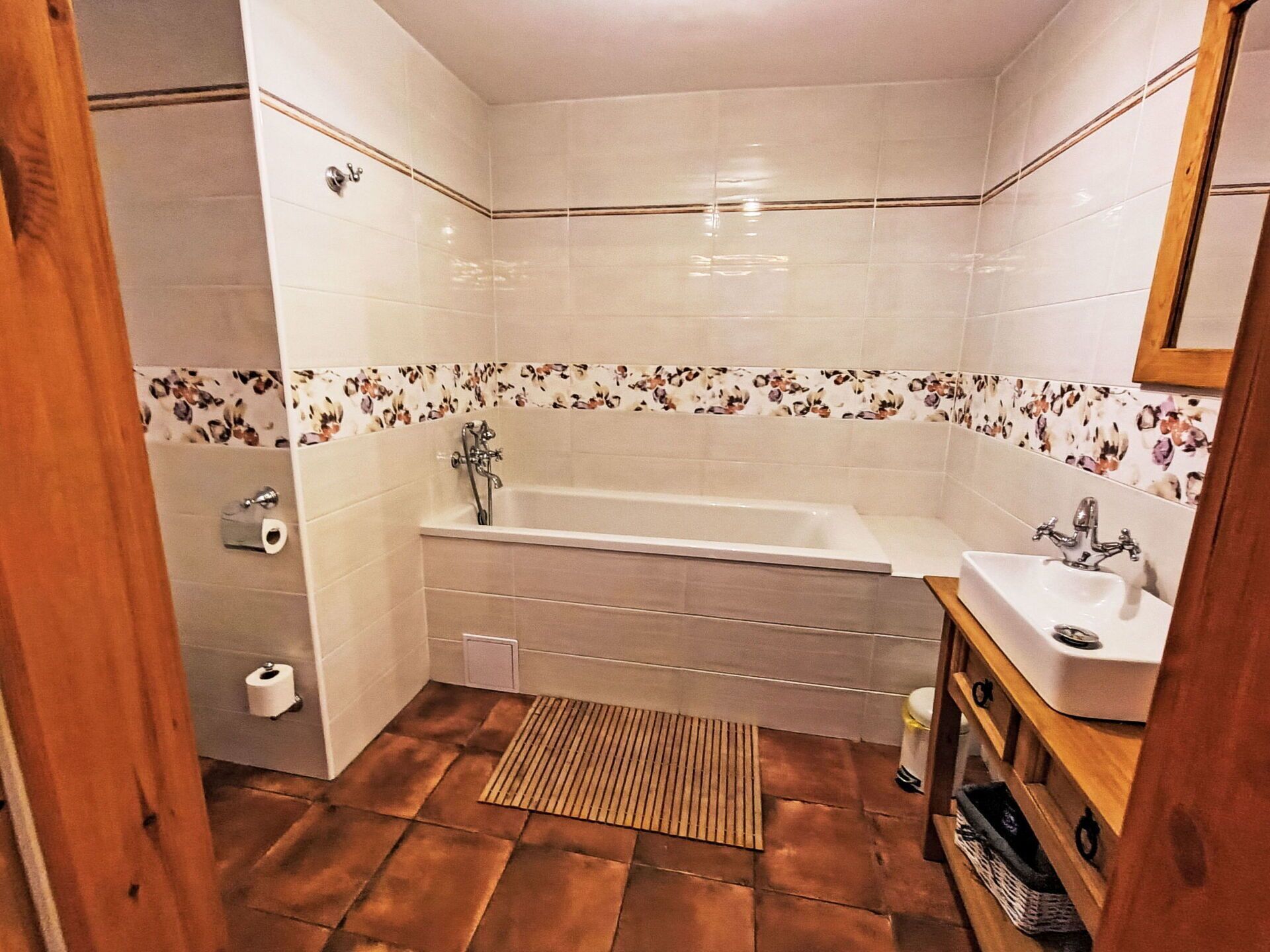 A bathroom with a bathtub, a sink, and a shower.