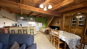 A cozy interior with a dining area, kitchen, and a living space with a sofa.