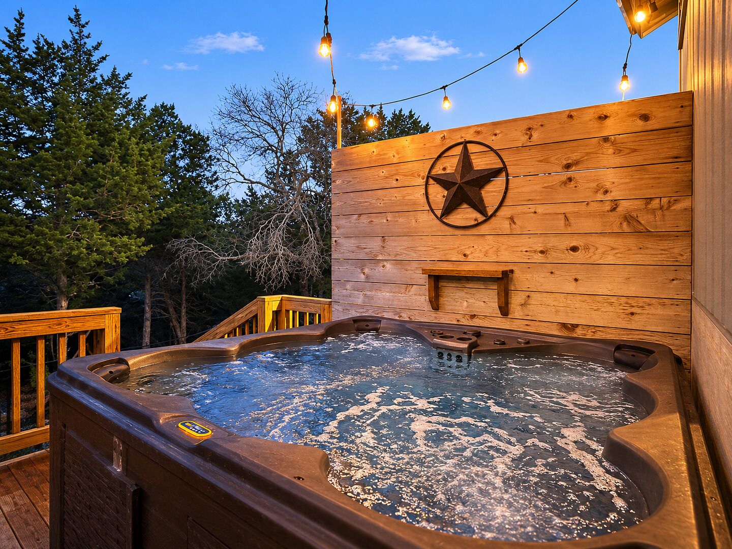 A wooden deck with a hot tub, string lights, and a star decoration.