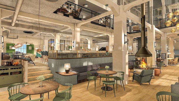 A spacious interior with high ceilings, a central bar area, multiple seating arrangements, and a visible staircase. - HENRI Hotel Cuxhaven (Cuxhaven)