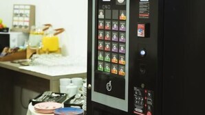 A vending machine with various drink options and a digital display. - Krško garni (Krsko)
