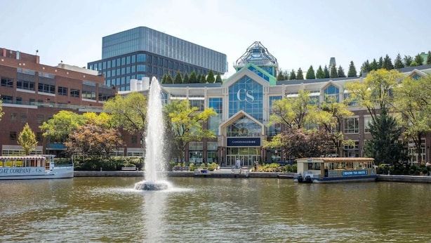 A fountain in a park with a building labeled "Cambridgeside" in the background.