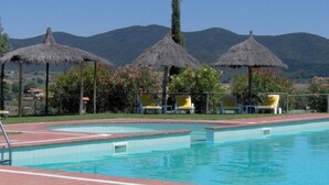 A swimming pool with a clear view of the mountains in the background.