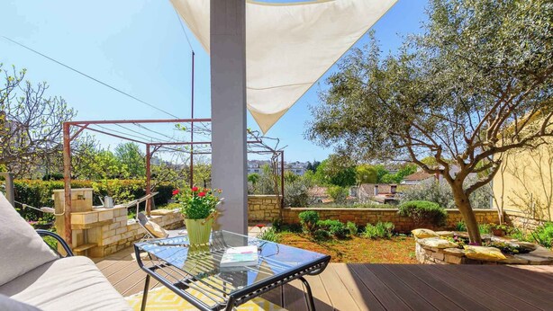 A patio with a glass table, a cushioned sofa, and a pergola with a white canopy. - Holiday apartment mit Klimaanlage (Pula)