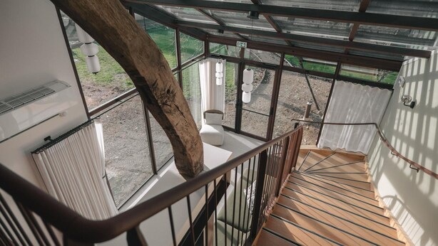 A staircase with a wooden handrail leading to a covered outdoor area with large windows. - 14th Century Authentic Charm with WiFi and Parking in Contigny (Contigny)