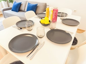 A dining table set with plates, cutlery, and juice bottles. - 2 Bedroom Apartments 18 Min to center (Vienna)