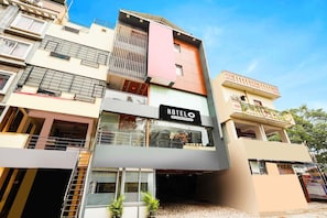 A multi-story hotel with a prominent "HOTELO" sign, balconies, and a ground-level entrance.