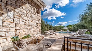 A stone building with a pool, lounge chairs, and a pergola. - Holiday Home Holiday Home Ivan with Heated Pool (Blato/Insel Korčula)