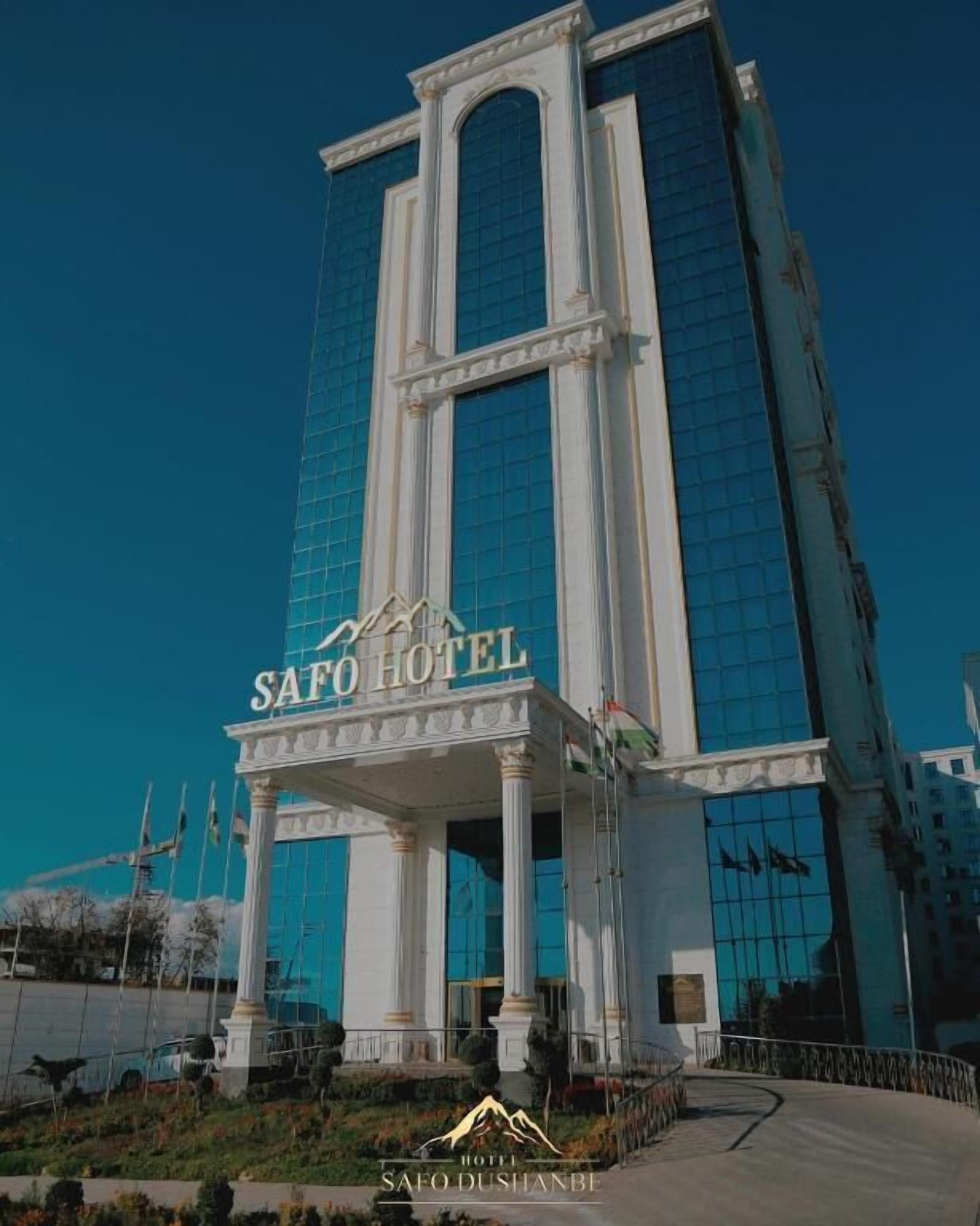 A tall hotel building with a prominent entrance and a sign reading "SAFO HOTEL".