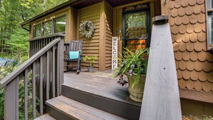 A wooden building with a 'WELCOME' sign, a bench, and a potted plant on the porch. - Newly Renovated! Peaceful Saylorsburg Home (Saylorsburg)