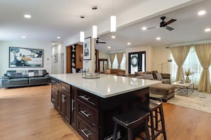 A modern kitchen with a large island, dark cabinetry, and pendant lighting. - Dog-friendly Home 6 Mi to Big Boulder Mtn! (Albrightsville)