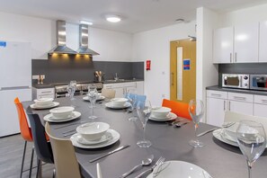A modern kitchen with a dining table set for a meal.
