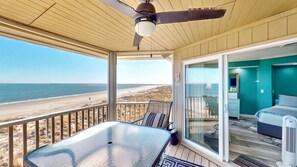 A balcony with a glass table and chairs, overlooking a beach. - Oceanfront Wild Dunes Condo with Direct Beach Access & Unobstructed Views (Isle of Palms)