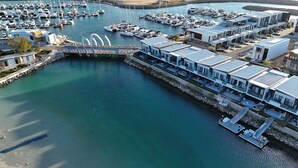 A marina with modern residential buildings, a bridge, and numerous boats. - Waterfront Retreat-North Coogee, beachfront,Sauna, family friendly, Fremantle (North Coogee)