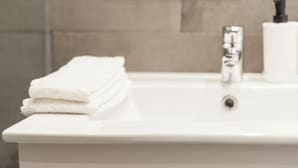 A bathroom sink with a white faucet and a bottle of soap. - Eden Island Maison by Olala Homes  (Mahe Island)