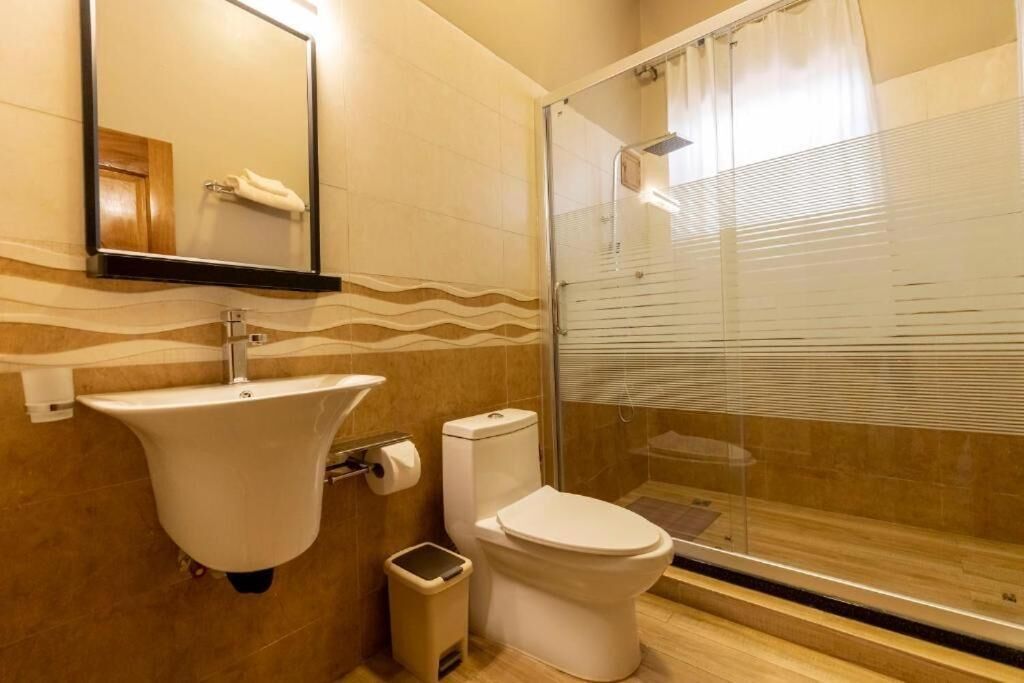 A bathroom with a sink, toilet, and shower.