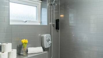 Combined shower/bathtub, deep-soaking bathtub, hair dryer, towels