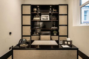 A modern office desk with a telephone, a notepad, and a clock. - Royal Knightsbridge 3-bed Next To Harrods (London)