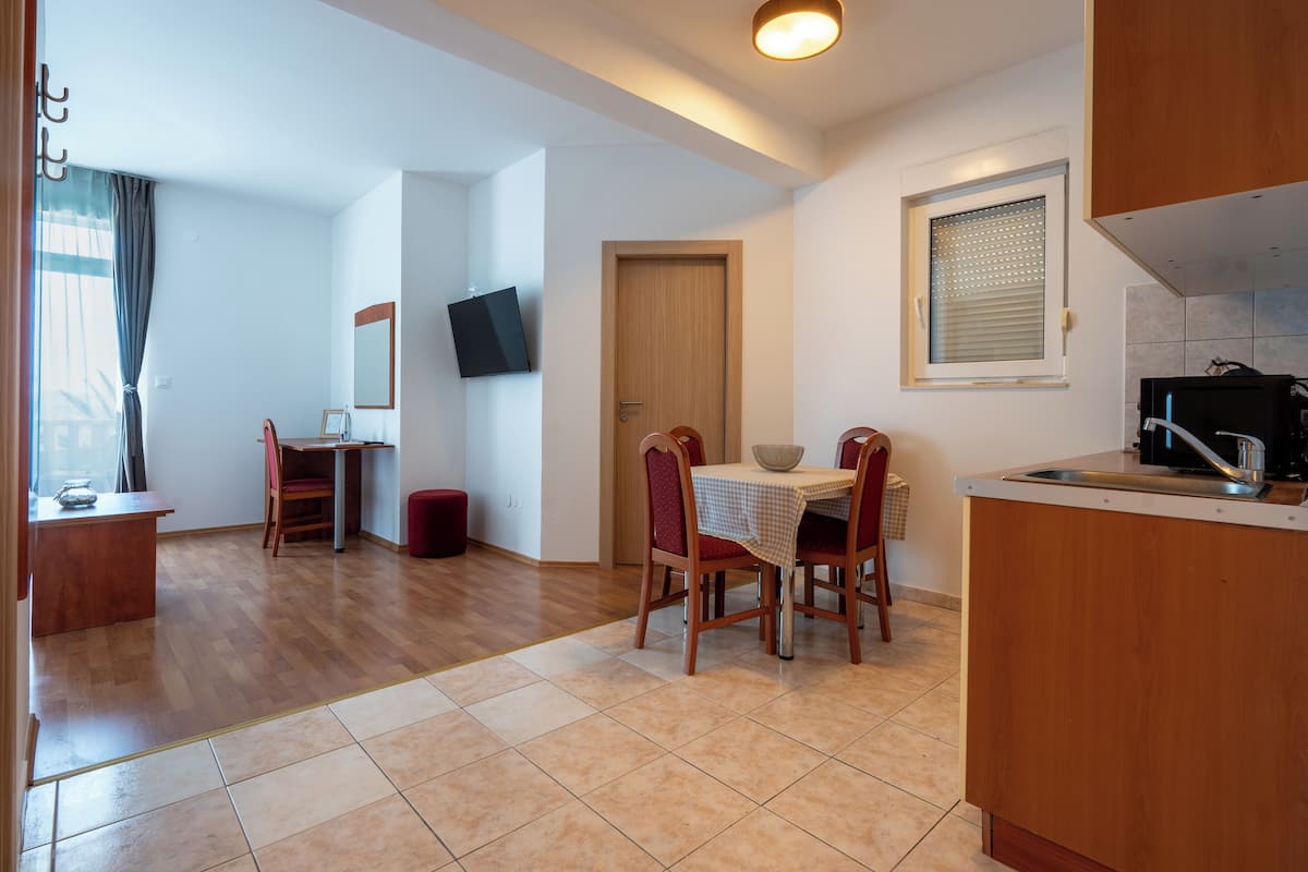 Family Apartment, Balcony, Sea View | Living area | 80-cm flat-screen TV with cable channels