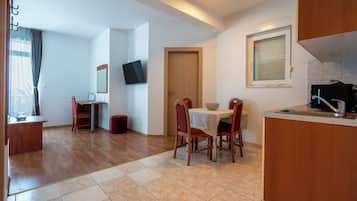 Family Apartment, Balcony, Sea View | Living area | 80-cm flat-screen TV with cable channels