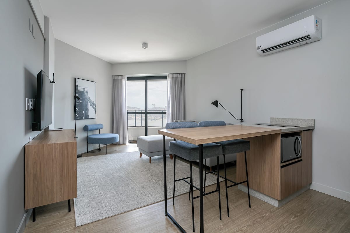 A modern apartment with a kitchen, dining area, and living space.