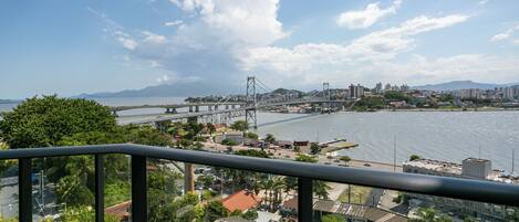 A cityscape with a prominent bridge, buildings, and a body of water.