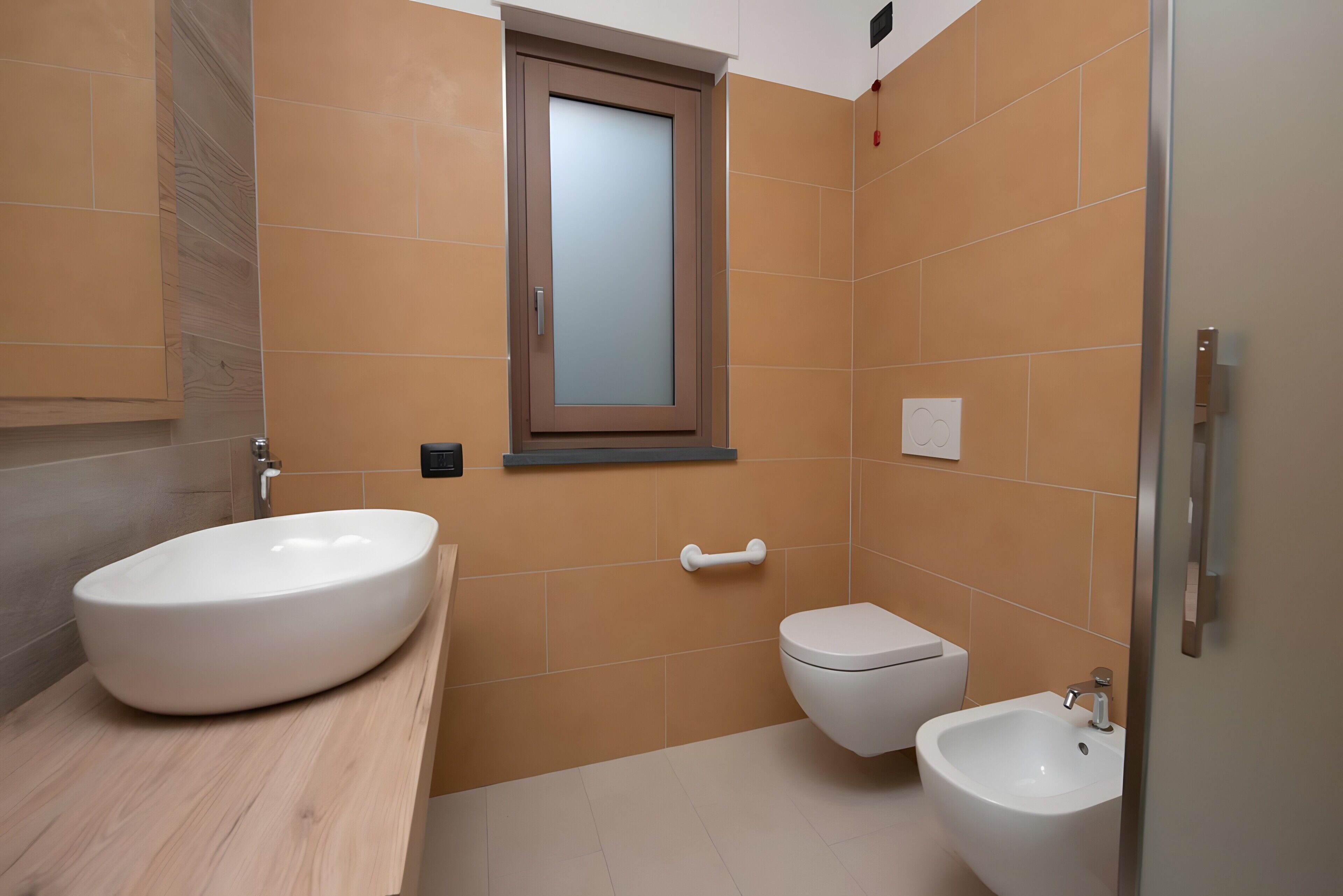 Un bagno con un lavabo ovale grande, un water e un bidet.