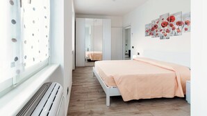 A bedroom with a large bed, a wardrobe, and a mirror. - Lake Como Retreat - Menaggio (Menaggio)