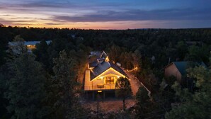 A house surrounded by trees with a visible garage and a small deck. - Luxe Forest A-Frame Escape w/ Deck & Fire-Pit (Heber-Overgaard)