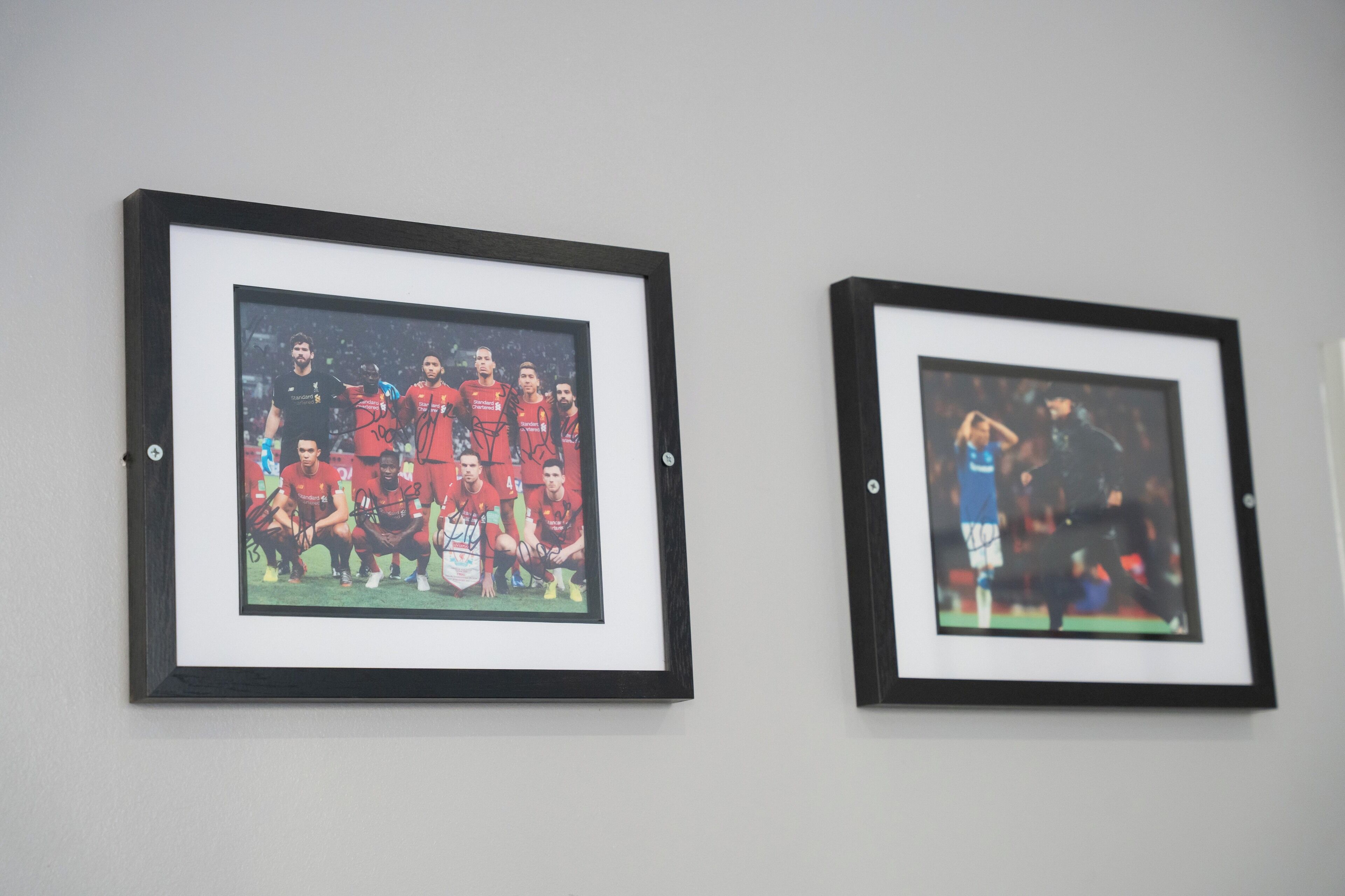 Two framed photographs on a wall.