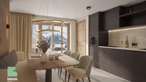 A modern dining area with a wooden table, chairs, and a vase of flowers. A large window offers a view of mountains.