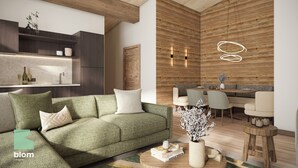 A modern living room with a green sofa, wooden accents, and a dining area with patterned chairs.