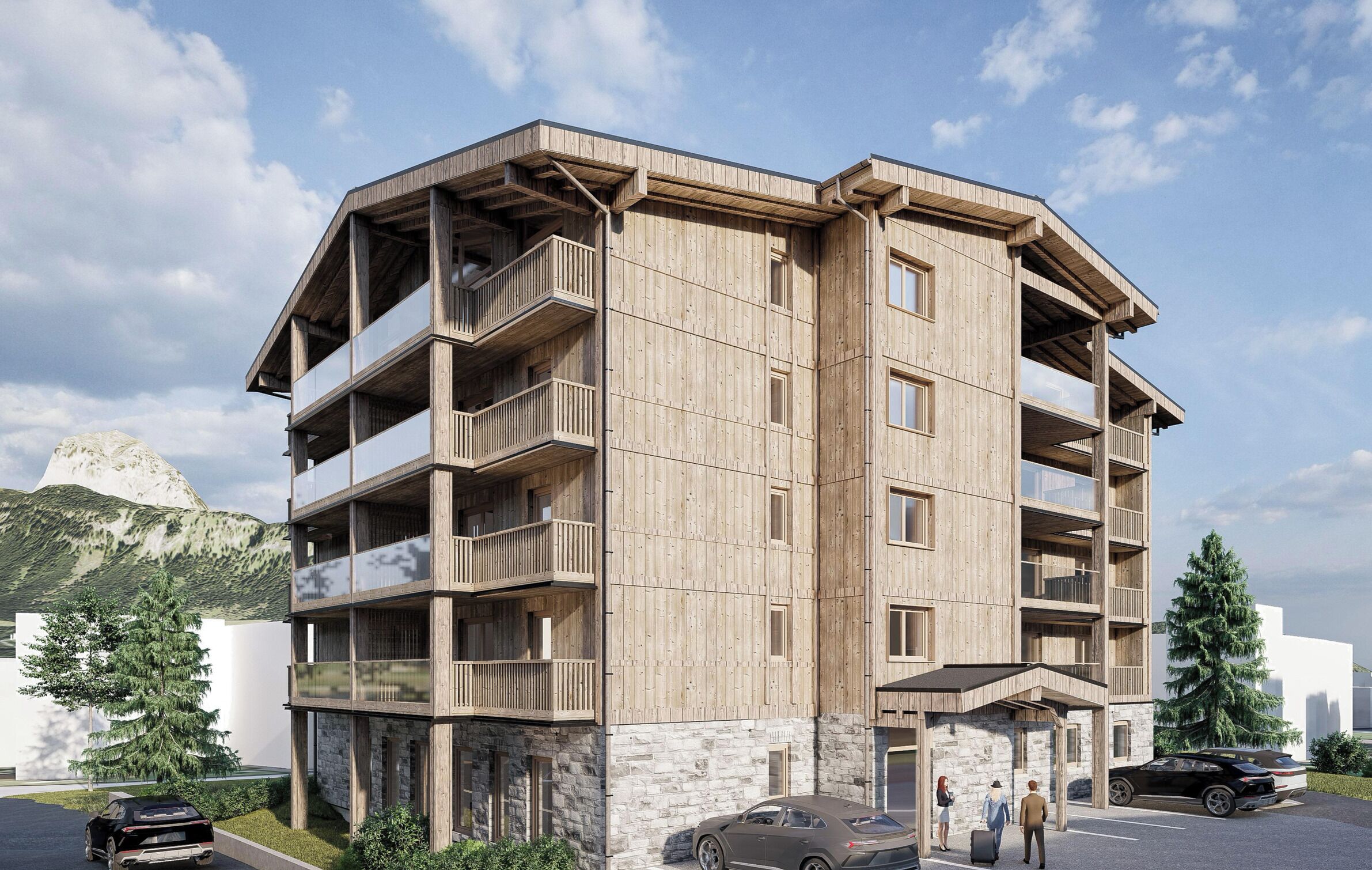 A multi-story building with balconies, a stone base, and a parking area with cars.