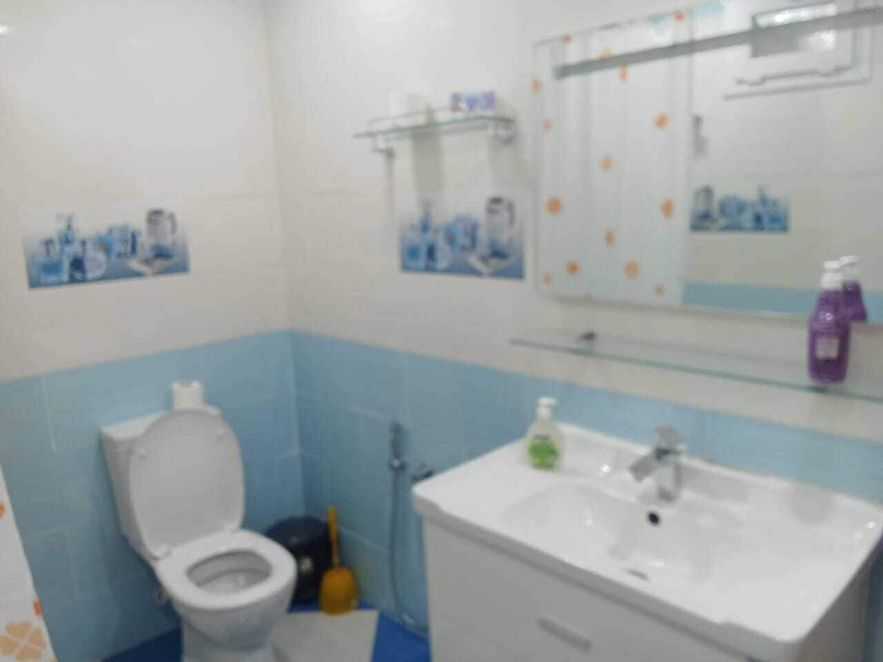 Ein Badezimmer mit Toilette, Waschbecken und Spiegel.