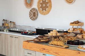 A buffet with various food items and a wooden counter.