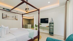 Ein modernes Schlafzimmer mit einem Himmelbett, einer Couch, einem Fernseher und einer Pflanze.