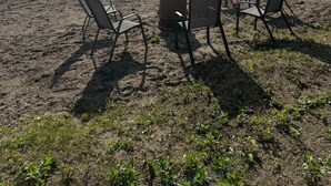 A beach with chairs and a dock extending into the water. - Cabin with private dock/beach access to Lake Minnewaska (Glenwood)