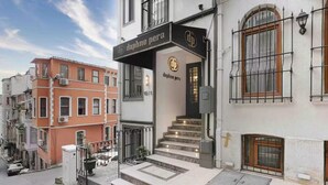 A building with a sign reading "daphne pera" and a staircase leading to the entrance. - Daphne Pera; Jasmin Apart, City Center (Beyoglu)