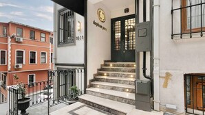 A building entrance with a marble staircase, a black door, and a sign reading "daphne spa". - Daphne Pera ; Sakura Apart, City Center (Beyoglu)