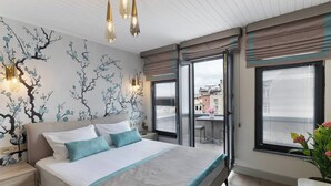 A modern bedroom with a large bed, a nightstand, a window with blinds, and a view of the city. - The One Taksim 105 Room, Comfort & Privacy (Beyoglu)