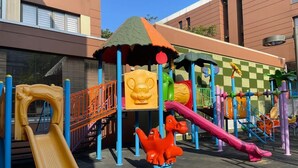 A children's playground with slides and climbing structures. - Peravi Suites at Pearl In The City (Accra)