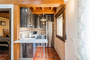 A compact kitchen with a white countertop, stainless steel appliances, and a wooden ceiling. - Country House 'Dehesa de Santa Ursula 3' with Garden and Balcony (Espeja De San Marcelino)