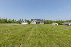 A residential property with a large lawn, a main house, and a detached garage. - Morrison’s Beach Road Island Retreat (Georgetown)