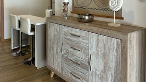 A modern kitchen with a wooden cabinet, a map on the wall, and an air conditioning unit. - Apartment in A Hotel 'Apartamento Type 2 A' with Private Terrace, Wi-Fi and Air Conditioning (Puente Genil)