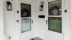 Two doors with numbers 134 and 136, each with a small window and a doorbell. - Boho abode Uptown Maumee by River-GREEN Side! (Maumee)