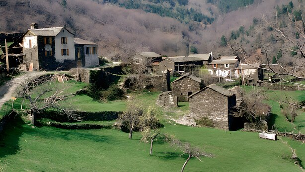 A rural village with stone buildings, a grassy field, and a mountain backdrop. - Bed and Breakfast 'Chambre Bleue - Ostau La Lutz' with Shared Terrace, Shared Garden and Wi-Fi (Saint-Germain-de-Calberte)