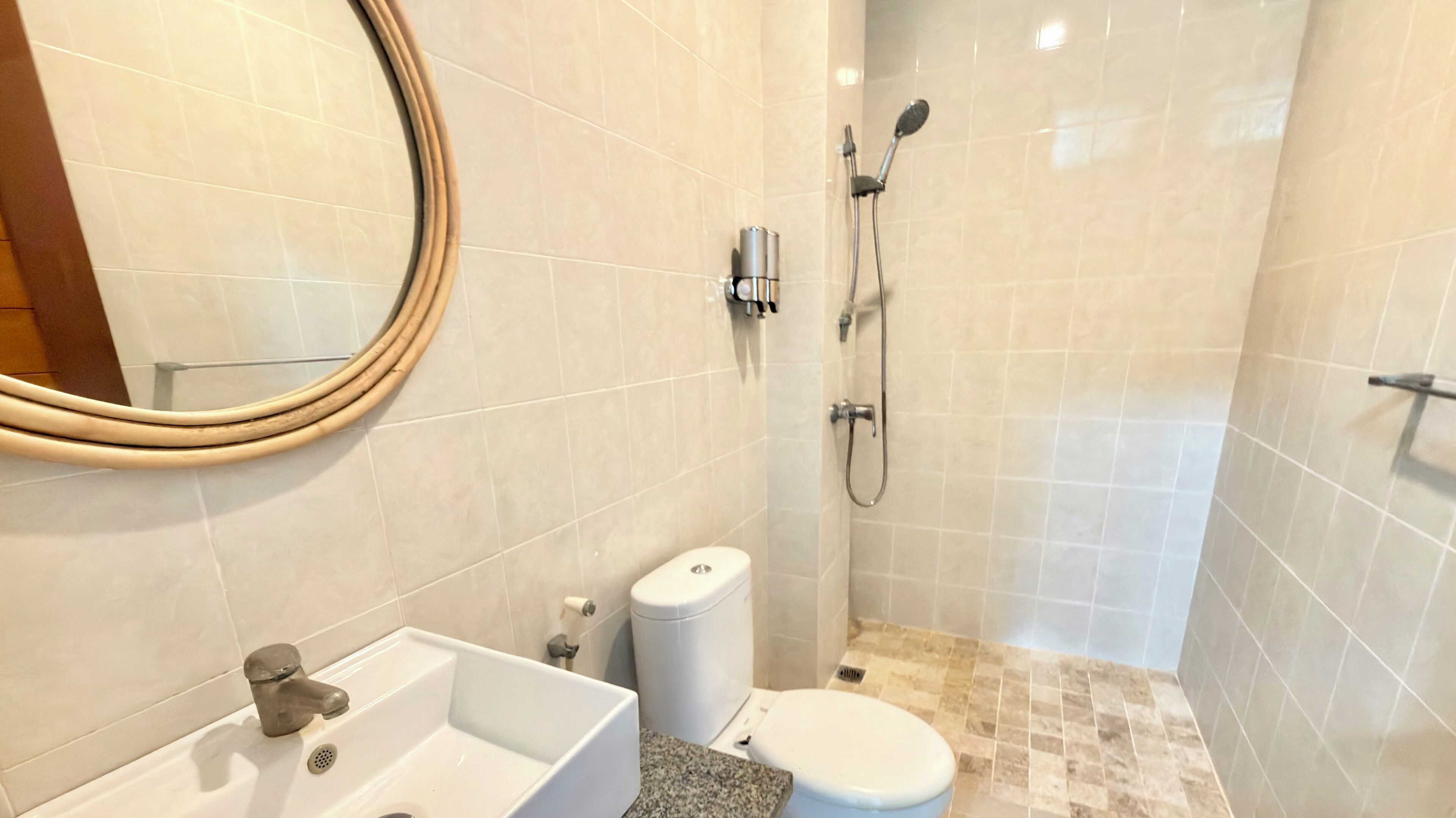 A bathroom with a sink, toilet, and shower.