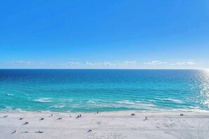 A beach with clear turquoise water and a sandy shore. - Let’s Flamingle! | Gorgeous Gulf Views! | 2PM Check In! | Pool, Hot Tub & Fitness Center Facing the Beach! Walk to Whale's Tail & More! | Fun and Funky Interior, Furnished Balcony! (Miramar Beach)